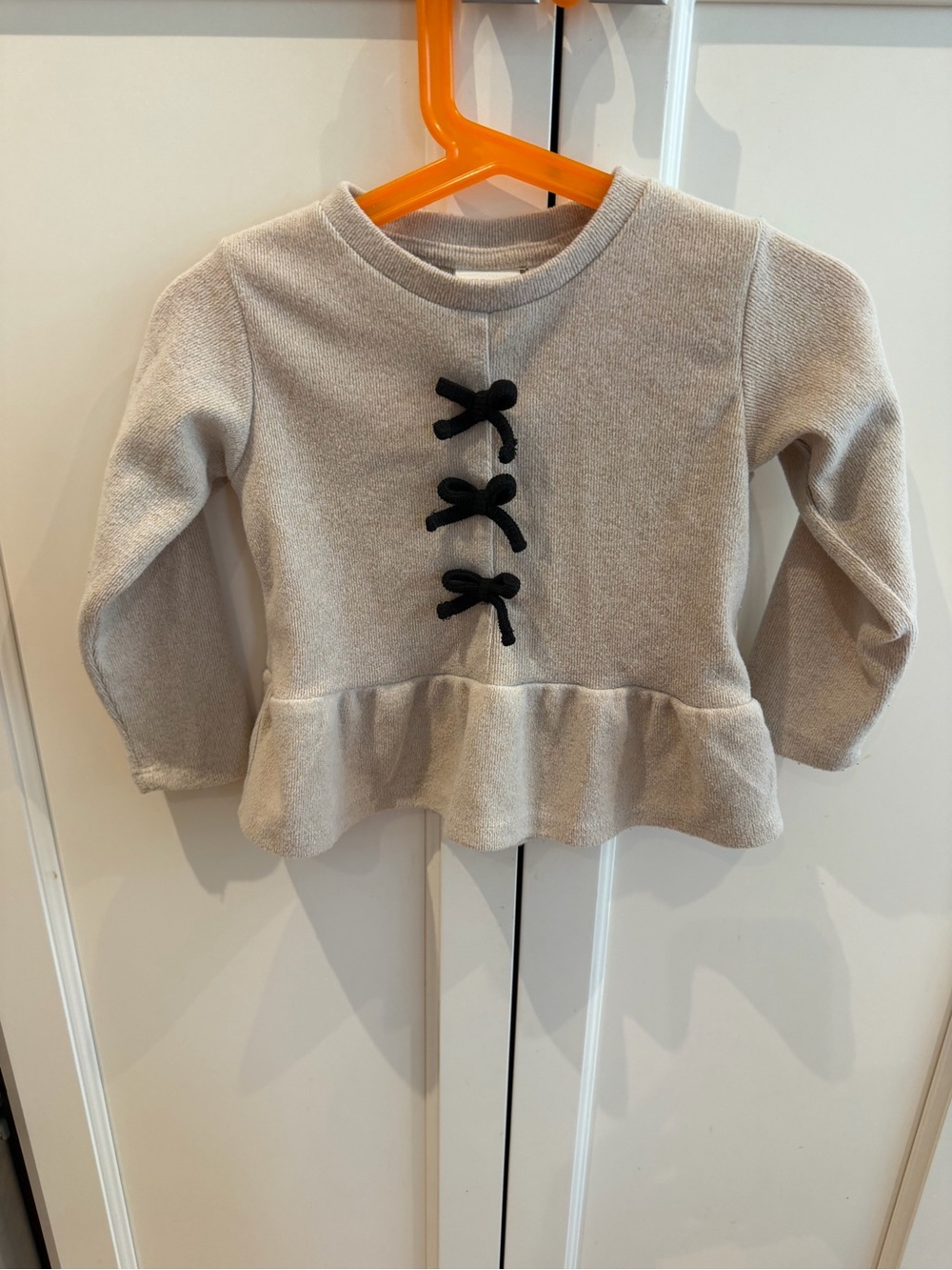 Zara 18m Cream Peplum Top with Black Bow Accents